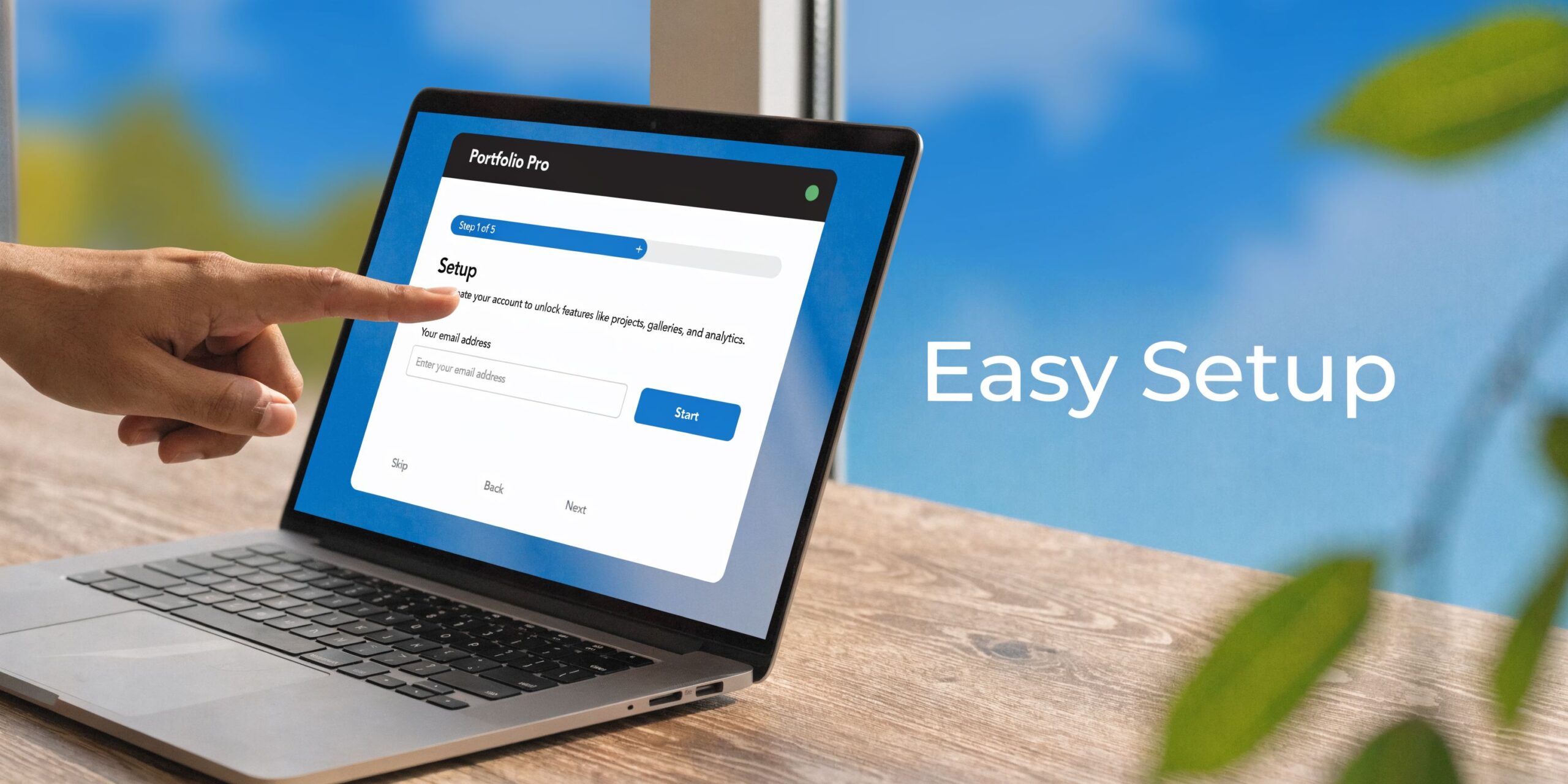 A person pointing to a laptop screen displaying a Portfolio Pro setup form for a new account.