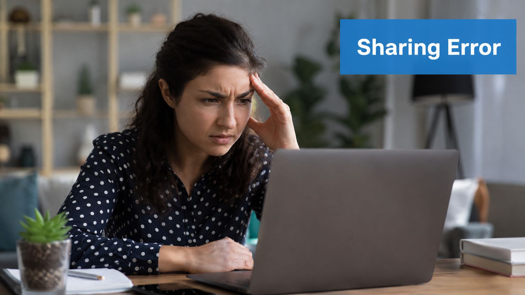 A concerned woman sits at her desk looking at her laptop screen with a frustrated expression.
