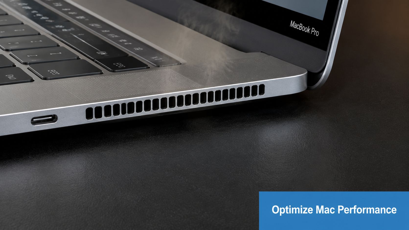 A silver MacBook Pro laptop on a desk emitting steam from its side air vents.